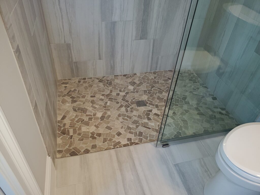 Modern Walk-In Shower with River Rock Pan